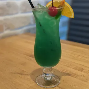 a green drink with a garnish