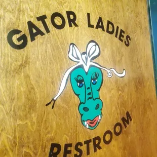 a sign for gator ladies&apos;s restroom