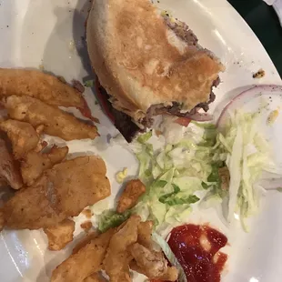 What is left of American cheeseburger and onion petals