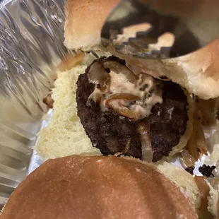 a hamburger being cut in half