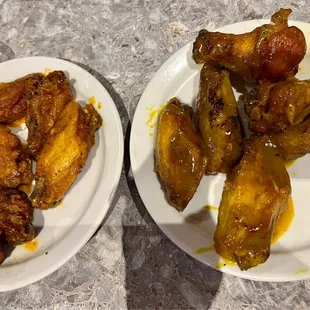 two plates of chicken wings