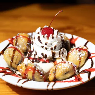 gator's grilled bananas topped with whipped cream, chocolate sauce and a cherry