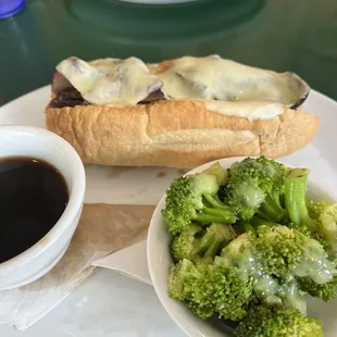 a hot dog with gravy and broccoli