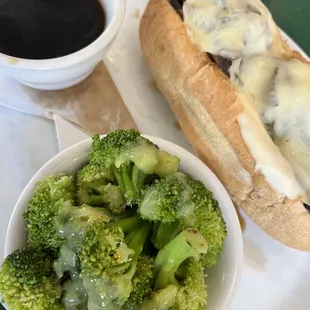 a bowl of broccoli and a hot dog