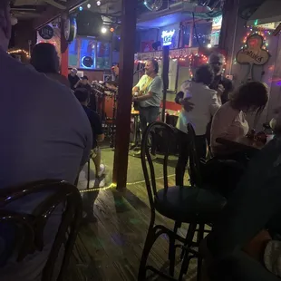 a group of people sitting at a bar