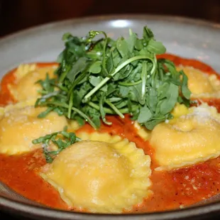 The Lobster Ravioli was made with cream, tomato conserva, arugula, &amp; lemon oil.