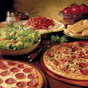 a variety of pizzas on a table