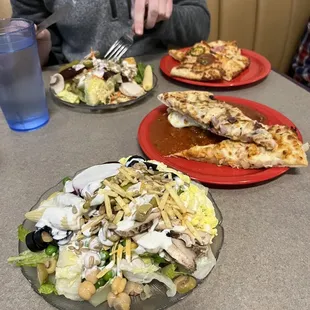 a man sitting at a table with plates of food
