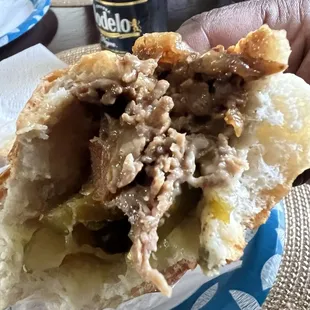 Cheesesteak with fried onions, sweet peppers and pickles. $24 Compare to their menu pictures