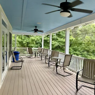 Lots of outdoor seating under a covered porch