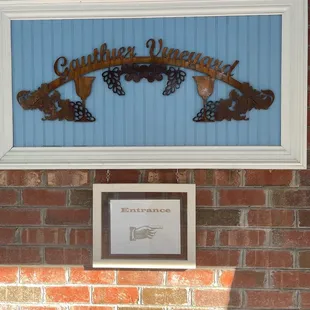 a sign on a brick wall