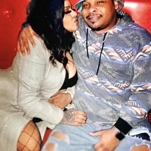 a man and woman sitting on a red couch