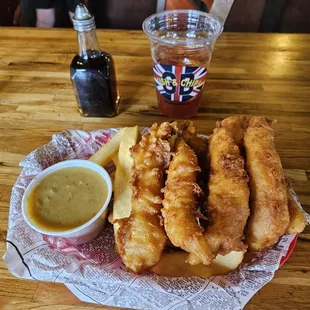6 pieces of fried cod with Chips underneath and Curry sauce + Iced Tea and malt vinegar