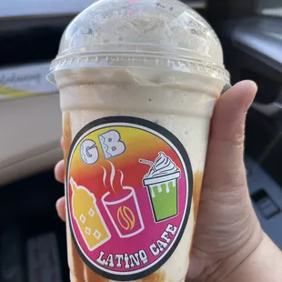 a hand holding a cup of iced coffee