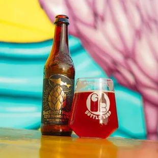 a glass of beer next to a beer bottle