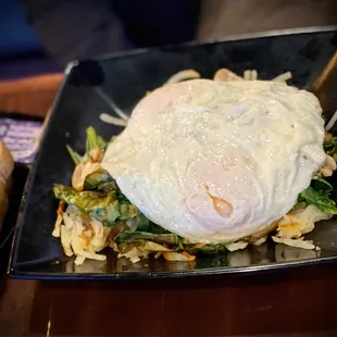 a fried egg on a bed of greens