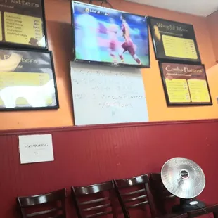 8 chairs line the walls for people to await their order for take-out.