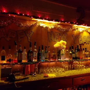 bottles of alcohol and glasses on a bar