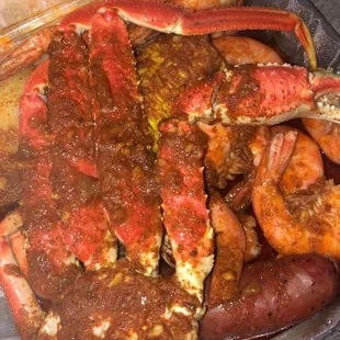 Seafood Box in HOT with Geaux sauce comes with snow crab cluster, boiled shrimp, corn, sausage, and potato