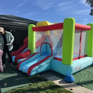 Toddler bouncer with slide and basketball hoop.