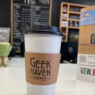 a cup of coffee with a sticker on it