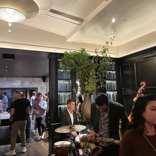 a group of people playing instruments in a bar