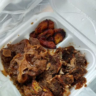 Jerk Chicken with Oxtails over rice, and Plantains