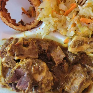 Curry goat, steamed cabbage and onion rings