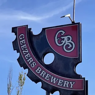 a sign for a brewery on a pole
