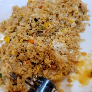 Fried rice undercooked and not mixed well. See the white?