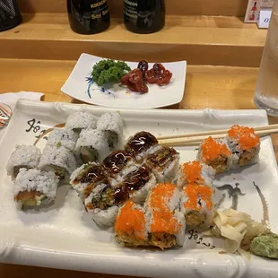 Various sushi rolls and a side of sashimi baby octopus