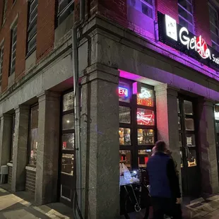 people walking in front of a restaurant