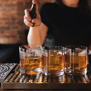 a bartender pouring a drink at a bar