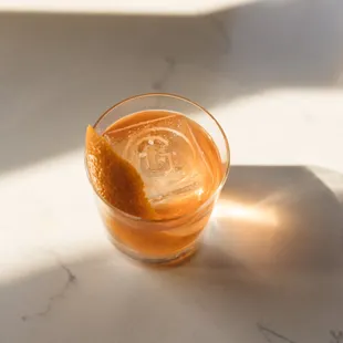 a glass of orange juice on a table