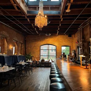 a long table with chairs and a chandelier