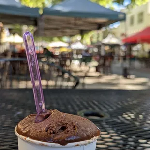 a chocolate ice cream in a paper cup