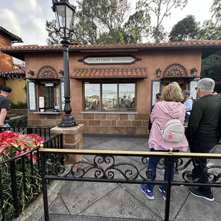 a group of people standing in front of a building