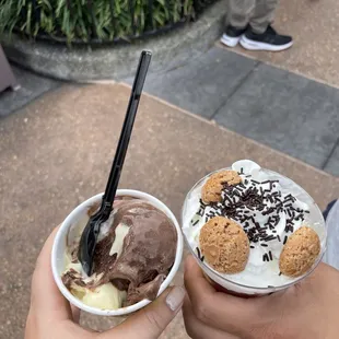 a person holding a cup of gelato