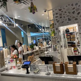 a woman and a man behind a counter