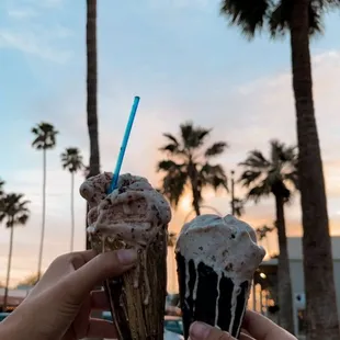 two people holding ice cream cones