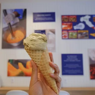 a hand holding an ice cream cone