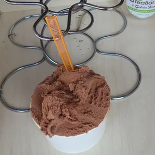 A medium scoop of ice cream in a cup.
