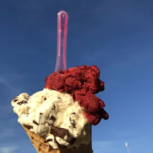 a hand holding a cone of ice cream