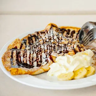 a plate of food with bananas and ice cream