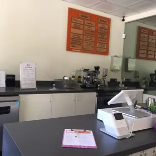 a counter with a counter top and a menu on the wall