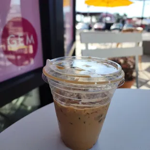 a cup of iced coffee on a table