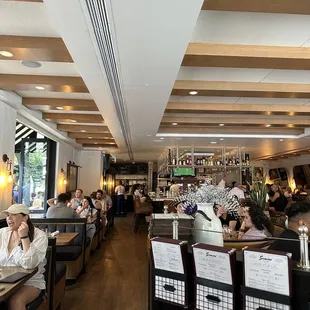 people sitting at tables in a restaurant