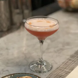 a plate of cookies and a drink on a table
