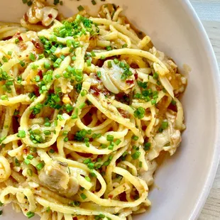 a bowl of pasta with mushrooms and parsley