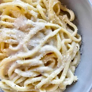 a bowl of pasta with parmesan cheese